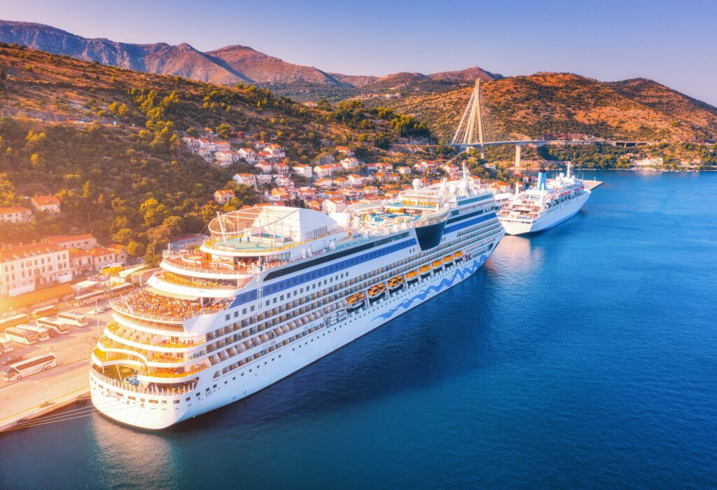 Aerial view of beautiful large white cruise ships at sunset