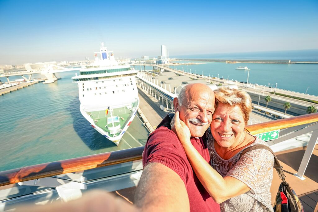 Senior happy couple taking selfie on ship on harbor background